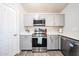 Well-lit kitchen with stainless steel appliances, ample counter space, and modern cabinetry at 9243 W Palmer Dr, Peoria, AZ 85345