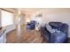 Cozy living room with wood-look tile flooring, two recliners, and a large window at 9243 W Palmer Dr, Peoria, AZ 85345