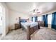 Comfortable main bedroom with plush carpeting, ceiling fan, and matching furniture at 9243 W Palmer Dr, Peoria, AZ 85345