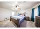 Well-lit main bedroom with a ceiling fan and an attractive decor that includes wood furniture at 9243 W Palmer Dr, Peoria, AZ 85345