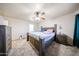 Inviting bedroom with ceiling fan, natural light, and matching wooden furniture at 9243 W Palmer Dr, Peoria, AZ 85345
