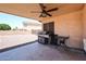 The covered patio features a ceiling fan, grill and outdoor seating area perfect for entertaining at 9243 W Palmer Dr, Peoria, AZ 85345