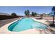 Inviting pool with lounge chairs, surrounded by desert landscaping and a privacy fence, perfect for relaxing at 9243 W Palmer Dr, Peoria, AZ 85345