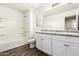 Bathroom with double sinks, vanity, mirror, and separate bath and shower at 925 E Agua Fria Ln, Avondale, AZ 85323