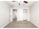 Bedroom that has open closet and entry with ceiling fan and carpet at 925 E Agua Fria Ln, Avondale, AZ 85323