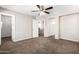 Comfortable carpeted bedroom with ample closet space and easy bathroom access at 925 E Agua Fria Ln, Avondale, AZ 85323