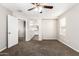 Spacious bedroom with a ceiling fan, carpet, and an en-suite bathroom at 925 E Agua Fria Ln, Avondale, AZ 85323