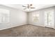Bright bedroom with ample windows and plush carpeting for added comfort at 925 E Agua Fria Ln, Avondale, AZ 85323