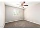 An empty bedroom with a ceiling fan and a large window with blinds at 925 E Agua Fria Ln, Avondale, AZ 85323
