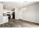 Cozy dining room featuring wood floors and white cabinetry in adjacent kitchen at 925 E Agua Fria Ln, Avondale, AZ 85323