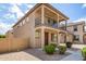Two-story home boasting a balcony and a well-maintained desert landscape at 925 E Agua Fria Ln, Avondale, AZ 85323