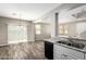 Open layout features granite countertops and seamlessly connects to the living area at 925 E Agua Fria Ln, Avondale, AZ 85323