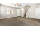 Open-concept living room with neutral paint, carpeted floor, and a ceiling fan at 925 E Agua Fria Ln, Avondale, AZ 85323