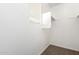 A compact walk-in closet that has a clothes rack and shelf above at 925 E Agua Fria Ln, Avondale, AZ 85323