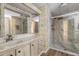 Bathroom features a vanity with marble countertop and a marble-lined walk in shower with glass doors at 9501 E Broadway Rd # Ofc, Mesa, AZ 85208