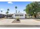 Charming single-story home with covered parking and a well-maintained front yard with lush green trees at 9501 E Broadway Rd # Ofc, Mesa, AZ 85208
