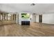 Inviting living area with wood-look floors, built in cabinet and entertainment center, adjacent to the kitchen at 9501 E Broadway Rd # Ofc, Mesa, AZ 85208