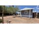 Manufactured home exterior features a detached storage building and a partially landscaped yard with native plants at 9632 E Arbor Cir, Mesa, AZ 85208