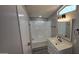 Bright bathroom features a tub and shower combo, a white vanity with updated fixtures, and a mirror at 9632 E Arbor Cir, Mesa, AZ 85208