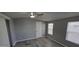 Neutral bedroom features updated flooring, a ceiling fan, and a window that brings in plenty of light at 9632 E Arbor Cir, Mesa, AZ 85208