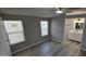 A bedroom featuring new flooring, two windows, ceiling fan and attached bathroom with vanity at 9632 E Arbor Cir, Mesa, AZ 85208
