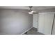 This bedroom features updated flooring, a ceiling fan, neutral walls, and a spacious closet with doors at 9632 E Arbor Cir, Mesa, AZ 85208