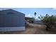 Manufactured home with a long covered carport and an adjacent storage building at 9632 E Arbor Cir, Mesa, AZ 85208