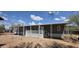 Manufactured home with white porch, multiple windows, desert landscaping, and metal support structure at 9632 E Arbor Cir, Mesa, AZ 85208