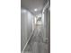 Hallway with updated gray flooring leads to a kitchen area at the end at 9632 E Arbor Cir, Mesa, AZ 85208
