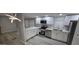 Updated kitchen features stainless appliances, white cabinets, and marble countertops at 9632 E Arbor Cir, Mesa, AZ 85208