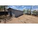 Backyard featuring metal storage building, partially framed with a metal support structure and native landscaping at 9632 E Arbor Cir, Mesa, AZ 85208