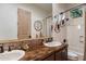 Bathroom with a double sink vanity, ornate mirror, and tiled countertop and shower at 9675 E Roadrunner Dr, Scottsdale, AZ 85262