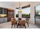 Cozy dining area with rustic table set, lots of natural light, and backyard access at 9675 E Roadrunner Dr, Scottsdale, AZ 85262