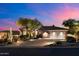 Stunning home exterior boasts desert landscaping and a spacious driveway leading to a two-car garage at 9675 E Roadrunner Dr, Scottsdale, AZ 85262