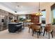Modern kitchen with a center island, stainless steel appliances, and adjacent dining area at 9675 E Roadrunner Dr, Scottsdale, AZ 85262