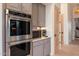 Modern kitchen featuring stainless steel appliances, microwave and stylish gray cabinetry and light countertops at 9675 E Roadrunner Dr, Scottsdale, AZ 85262