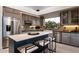 Stylish kitchen featuring a large island, modern appliances, and a window view of the lush landscape at 9675 E Roadrunner Dr, Scottsdale, AZ 85262