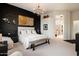 Spacious main bedroom with large windows, dark accent wall, stylish chandelier and unique decor at 9675 E Roadrunner Dr, Scottsdale, AZ 85262