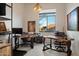 Bright home office featuring multiple desks, a large window, and views of the outdoors at 9675 E Roadrunner Dr, Scottsdale, AZ 85262