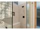 Close-up of the shower with custom tiling, built-in bench, and glass enclosure at 9675 E Roadrunner Dr, Scottsdale, AZ 85262