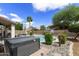 Private backyard with a pool, spa, covered patio, and well-maintained landscaping at 1072 W Windhaven Ave, Gilbert, AZ 85233