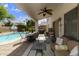 Inviting backyard oasis with a covered patio, pool, hot tub, and basketball hoop at 1072 W Windhaven Ave, Gilbert, AZ 85233