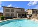 Backyard with refreshing pool, covered patio, and low-maintenance landscaping at 1072 W Windhaven Ave, Gilbert, AZ 85233