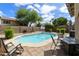 Backyard featuring a refreshing pool, lounge chairs, and a basketball hoop at 1072 W Windhaven Ave, Gilbert, AZ 85233