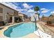 Aerial view of the backyard with a pool, patio, and lush landscaping at 1072 W Windhaven Ave, Gilbert, AZ 85233
