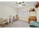 Cozy bedroom featuring carpeted floors, a ceiling fan, and cute decor at 1072 W Windhaven Ave, Gilbert, AZ 85233