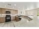 Spacious kitchen features granite countertops, oak cabinets, and stainless steel appliances at 1072 W Windhaven Ave, Gilbert, AZ 85233