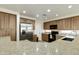 Well-lit kitchen with stainless steel appliances, spacious cabinets, and speckled granite countertops at 1072 W Windhaven Ave, Gilbert, AZ 85233