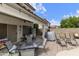Cozy covered patio features lounge seating, dining area, and access to a refreshing pool, perfect for outdoor entertaining at 1072 W Windhaven Ave, Gilbert, AZ 85233
