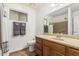 Clean bathroom with a large mirror, wood cabinets, and a shower-tub combination at 10940 E Olla Ave, Mesa, AZ 85212